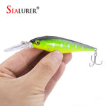 Sealurer floating fishing lure in 11cm length and bright green, silver and black decor on white background